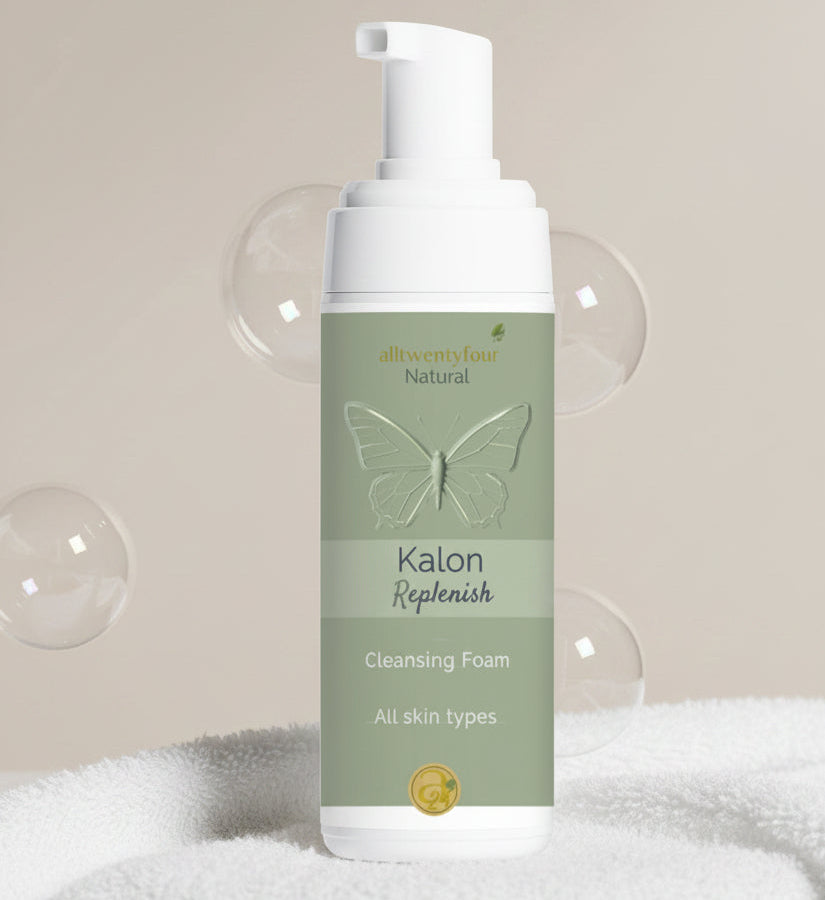 A bottle of Kalon Replenish Cleansing Foam by alltwentyfour, featuring a white pump and a sage green label with a butterfly graphic.