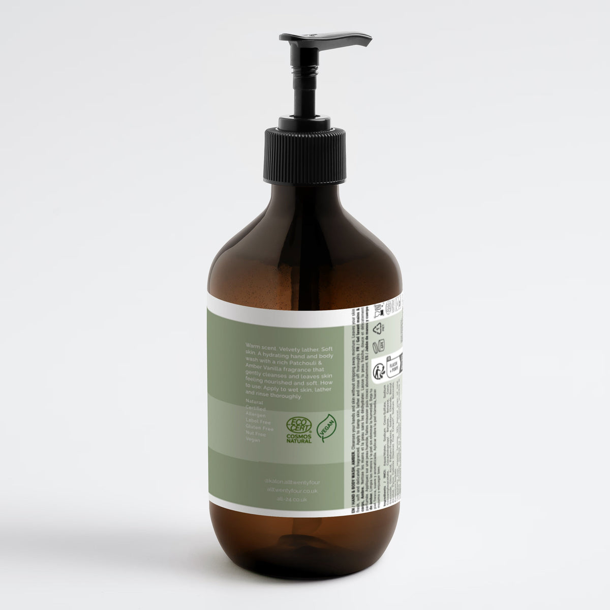 An amber glass Kalon pump bottle with a black dispenser and a sage green and white label, shown from a rear three-quarter view on a light gray background.